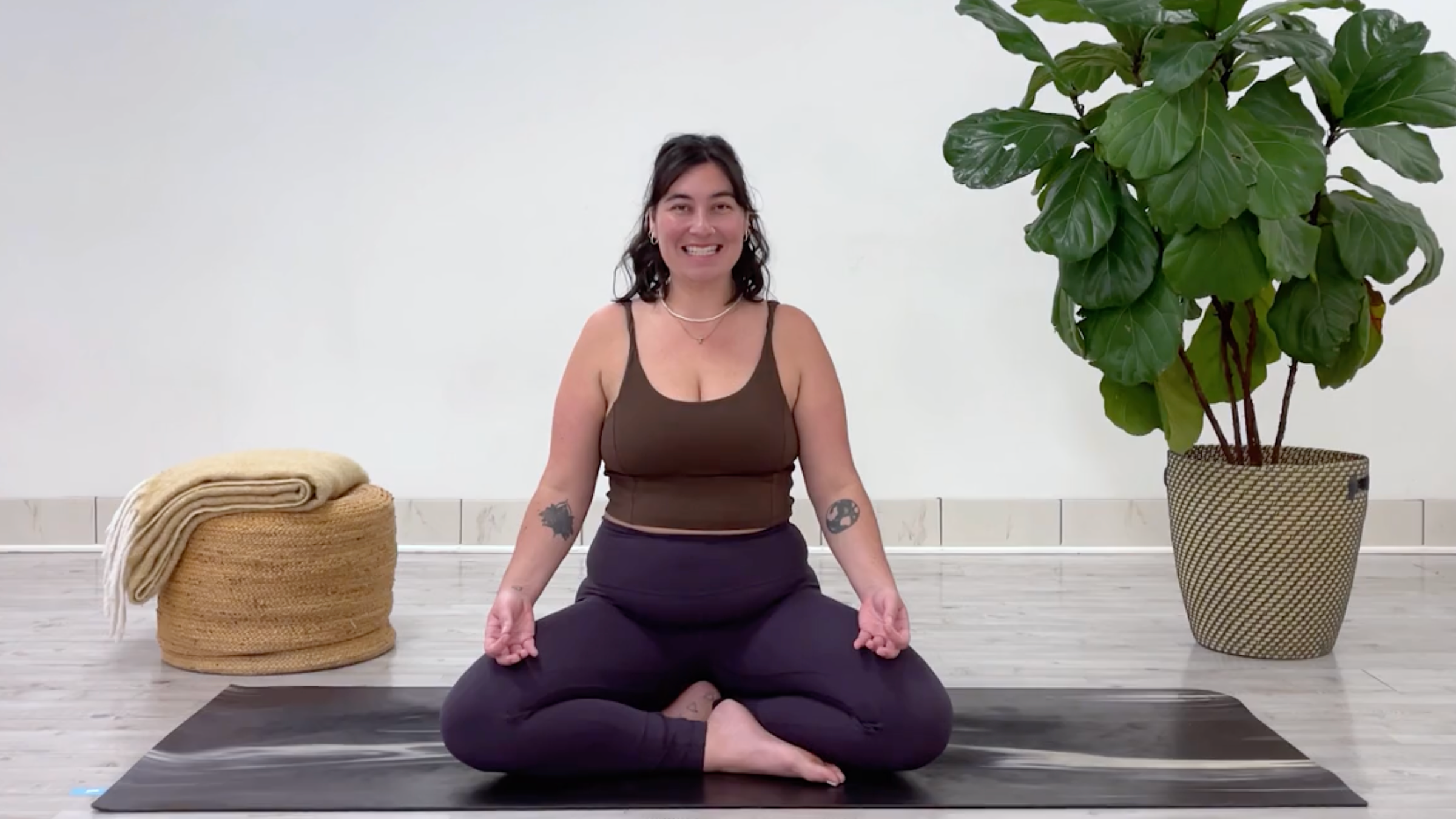 Yoga teacher Taylor Lorenz demonstrating sitali breath, a pranayama practice